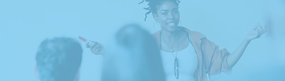 An instructor standing in front of a class of adult learners.