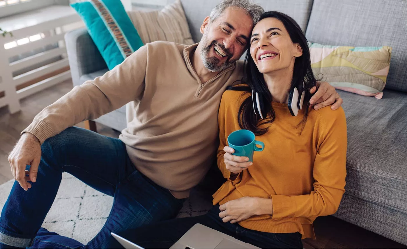  Couple sitting on the floor with a blue coffee mug
