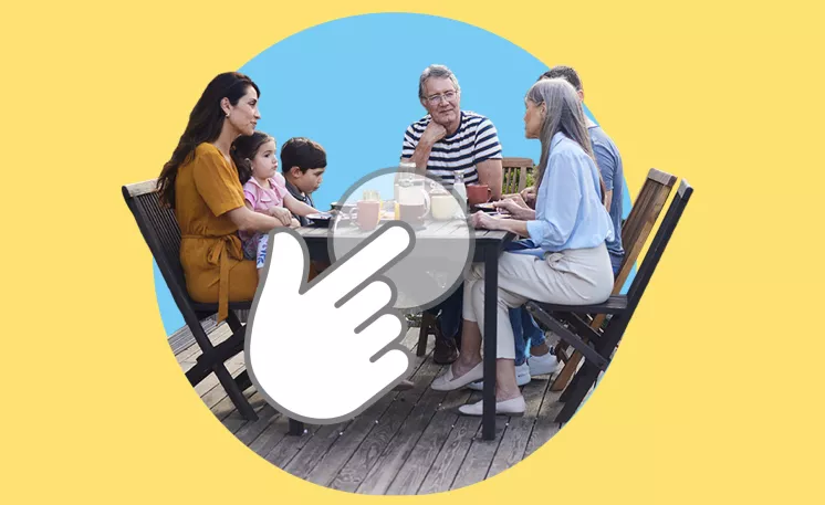 multi-generational family having a conversation while sitting around a table