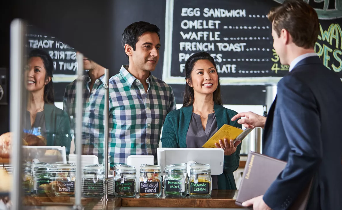 An Edward Jones advisor visits two small business owners at their cafe.
