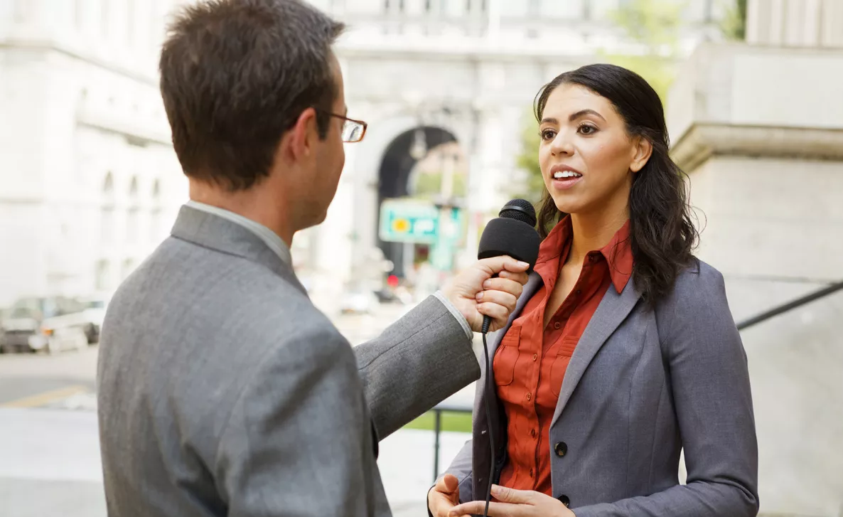  man holding microphone for a woman
