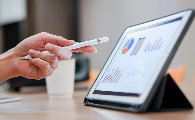 A tablet displaying financial charts and graphs. A tablet displaying financial charts and graphs.