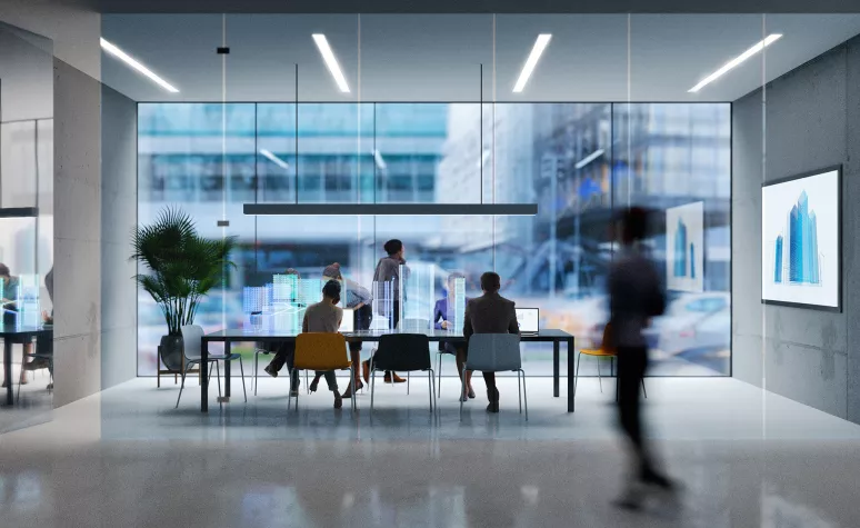 Employees talk together in a conference room of a modern office building. Employees talk together in a conference room of a modern office building.