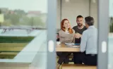 How investments taxed: A couple shakes hands with a tax advisor.