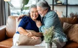 Couple hugging on a sofa