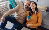 Couple sitting on the floor with a blue coffee mug